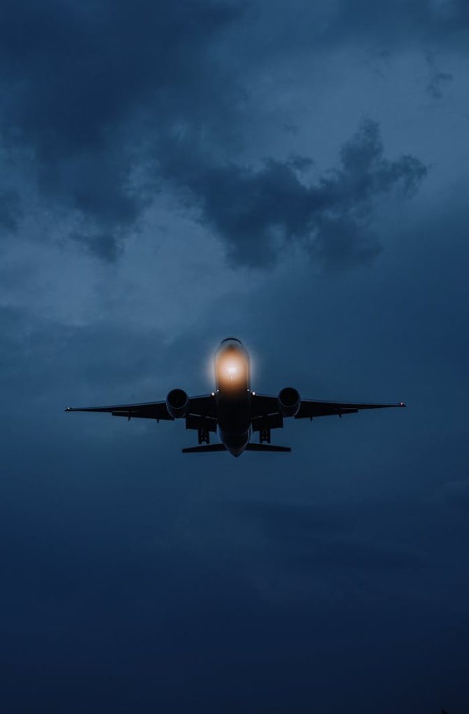 A dramatic shot of an airplane against a moody night sky in Istanbul.